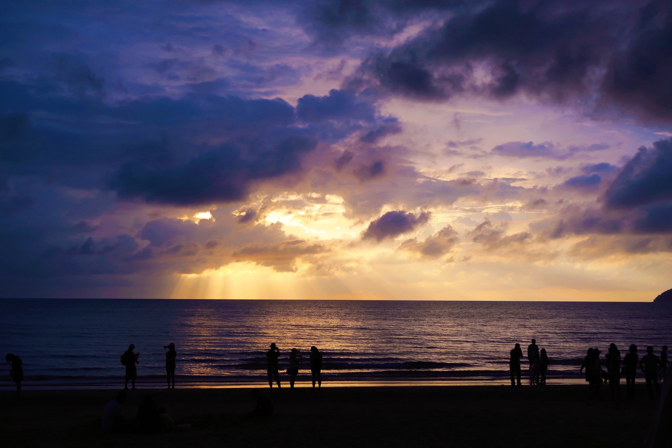 silhouette photo of people on beach on sunset