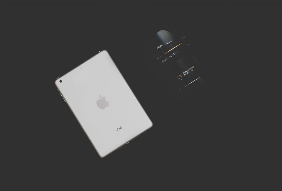 silver ipad and black camera lens preview