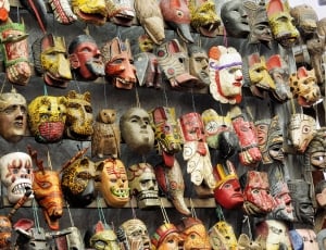 person takes picture of native masks thumbnail