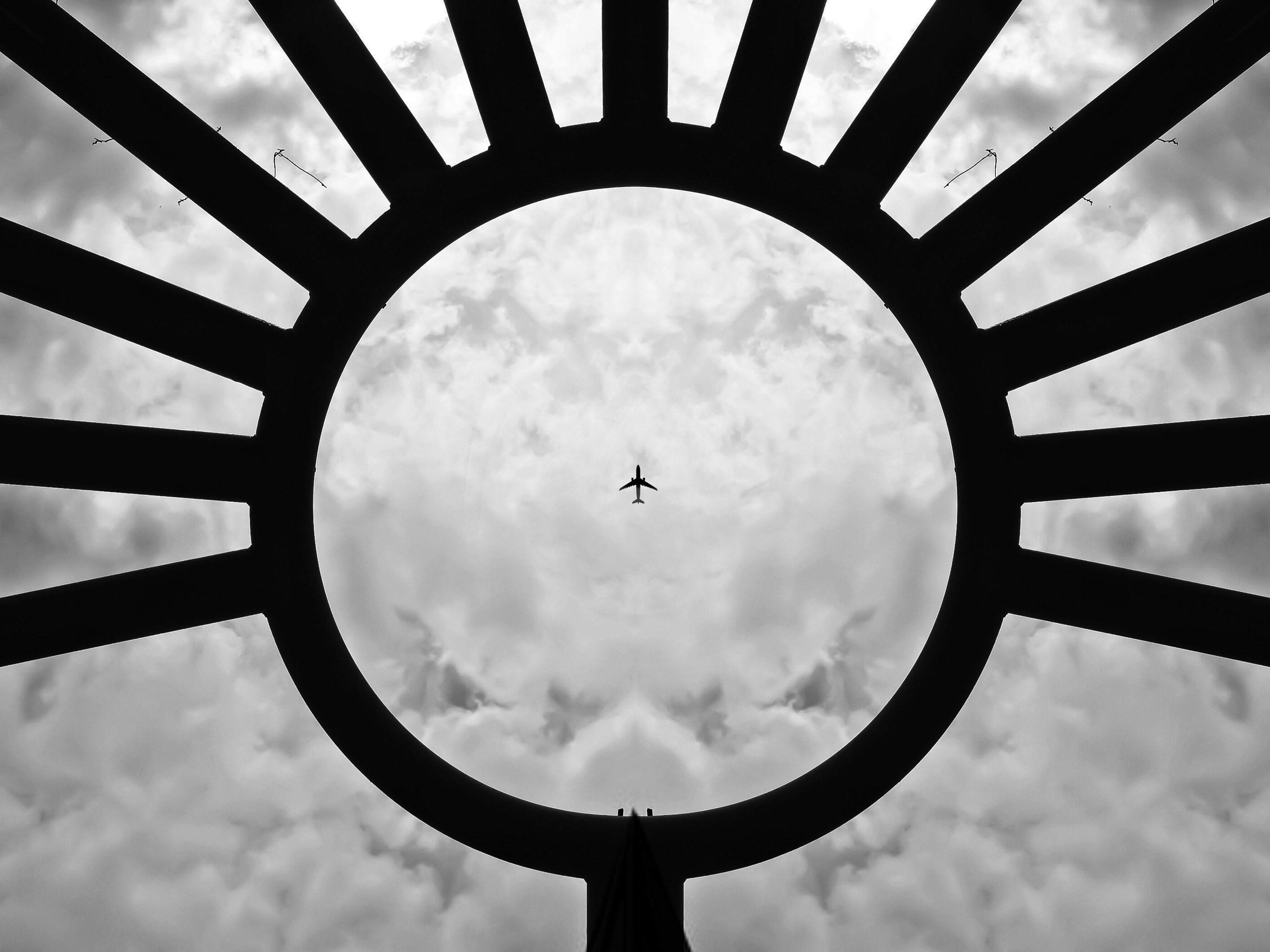 silhouette of plane and cumulus clouds