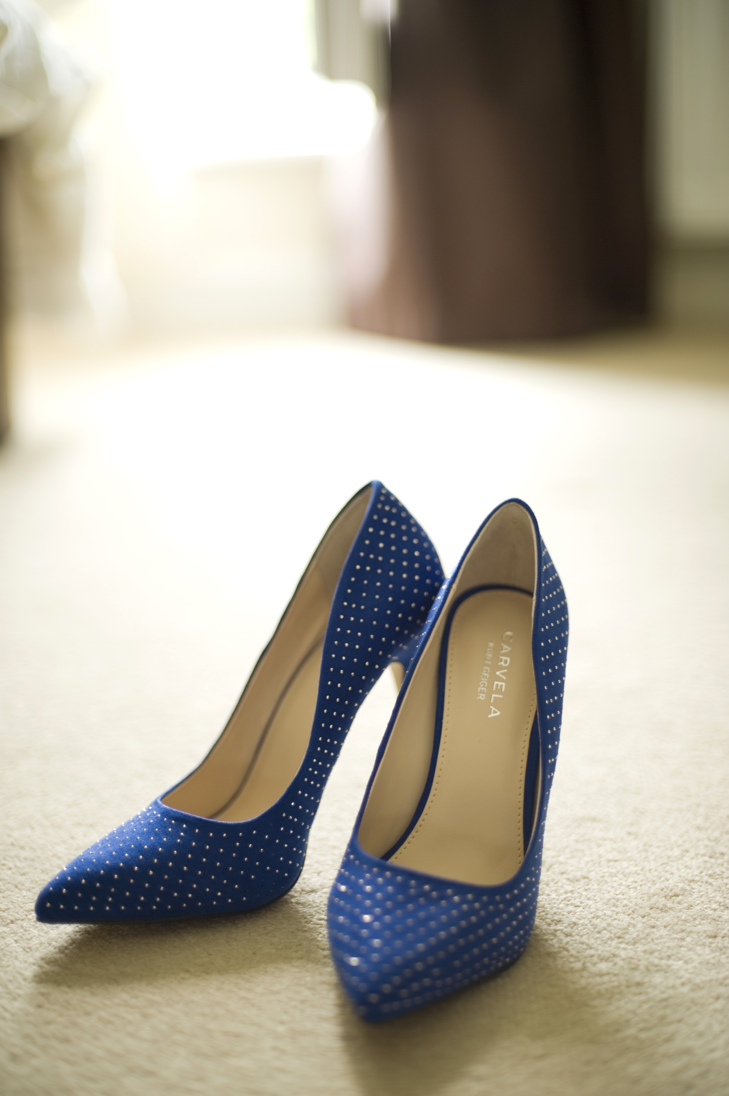 pair of blue and white polka dot leather pointed stiletto