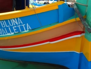 blue yellow red and brown boat thumbnail
