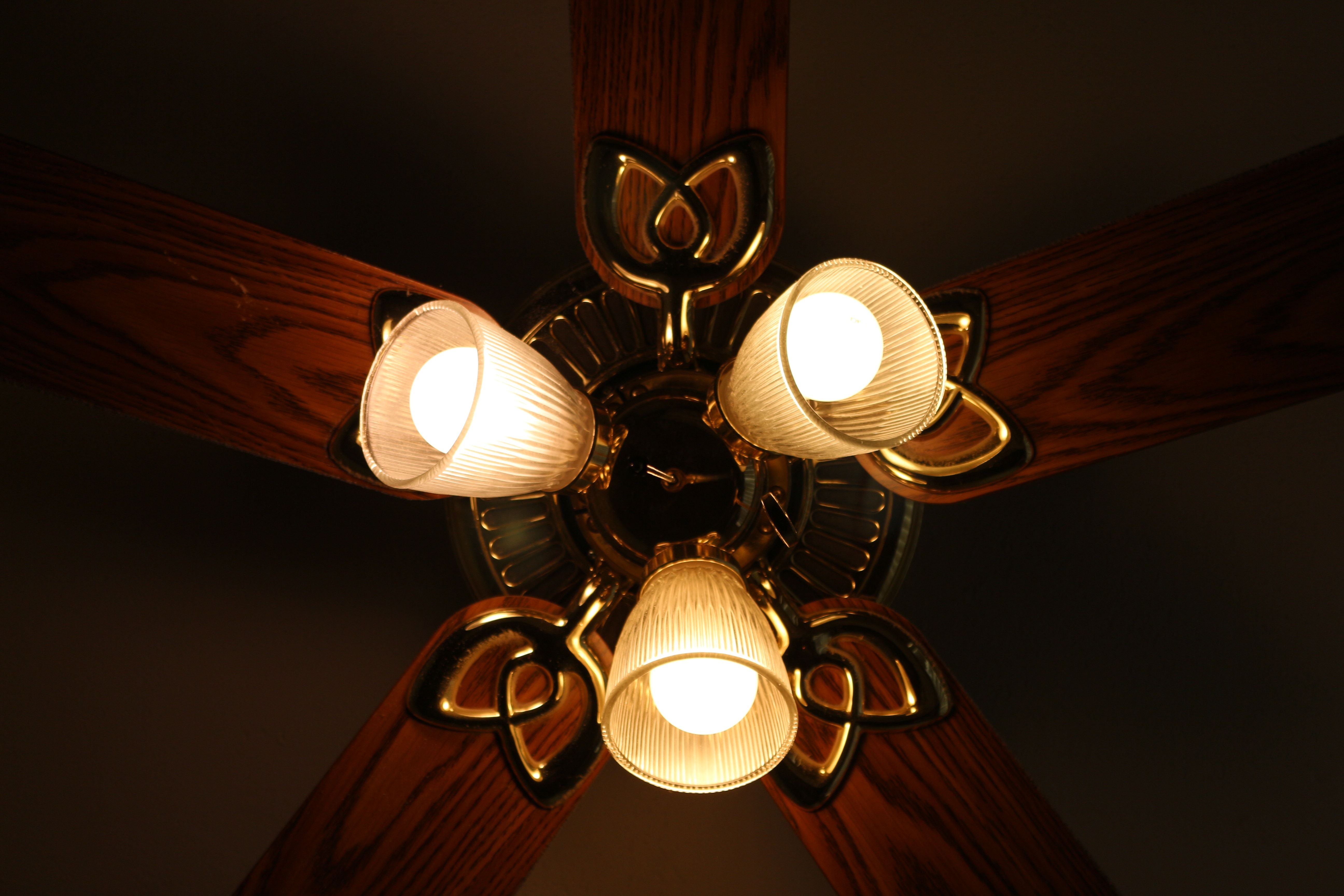 brown wooden 5 blade clear glass ceiling fan and lamp