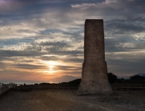 concrete structure near mountain during sunset thumbnail