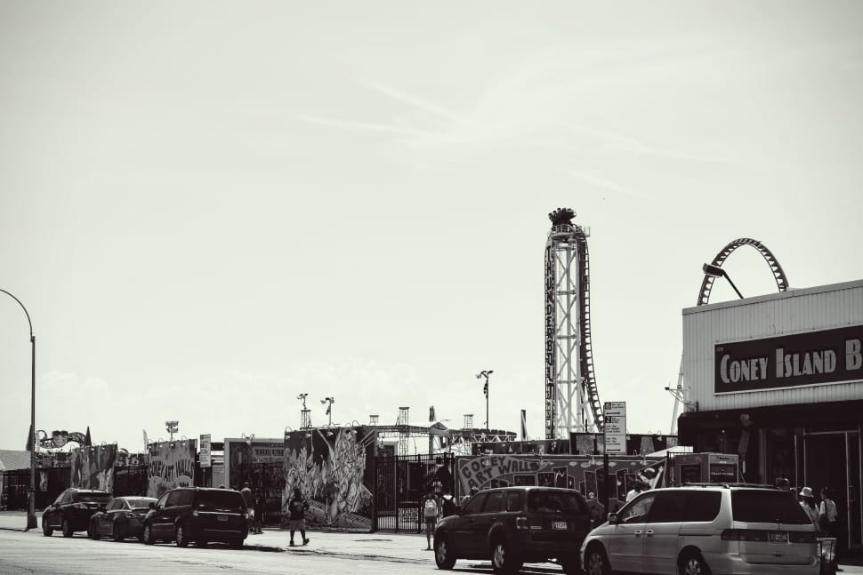 vintage grayscale photo of cars parked beside coney island building preview