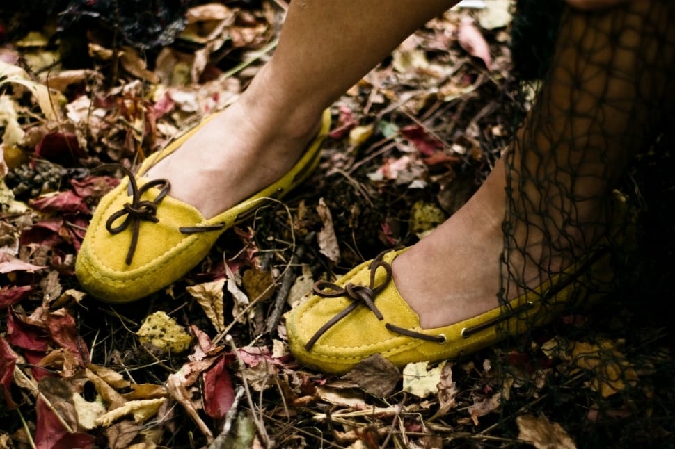 person wearing yellow suede boat shoes preview