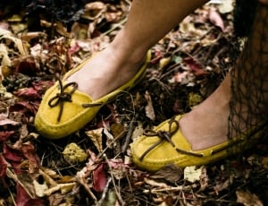 person wearing yellow suede boat shoes thumbnail