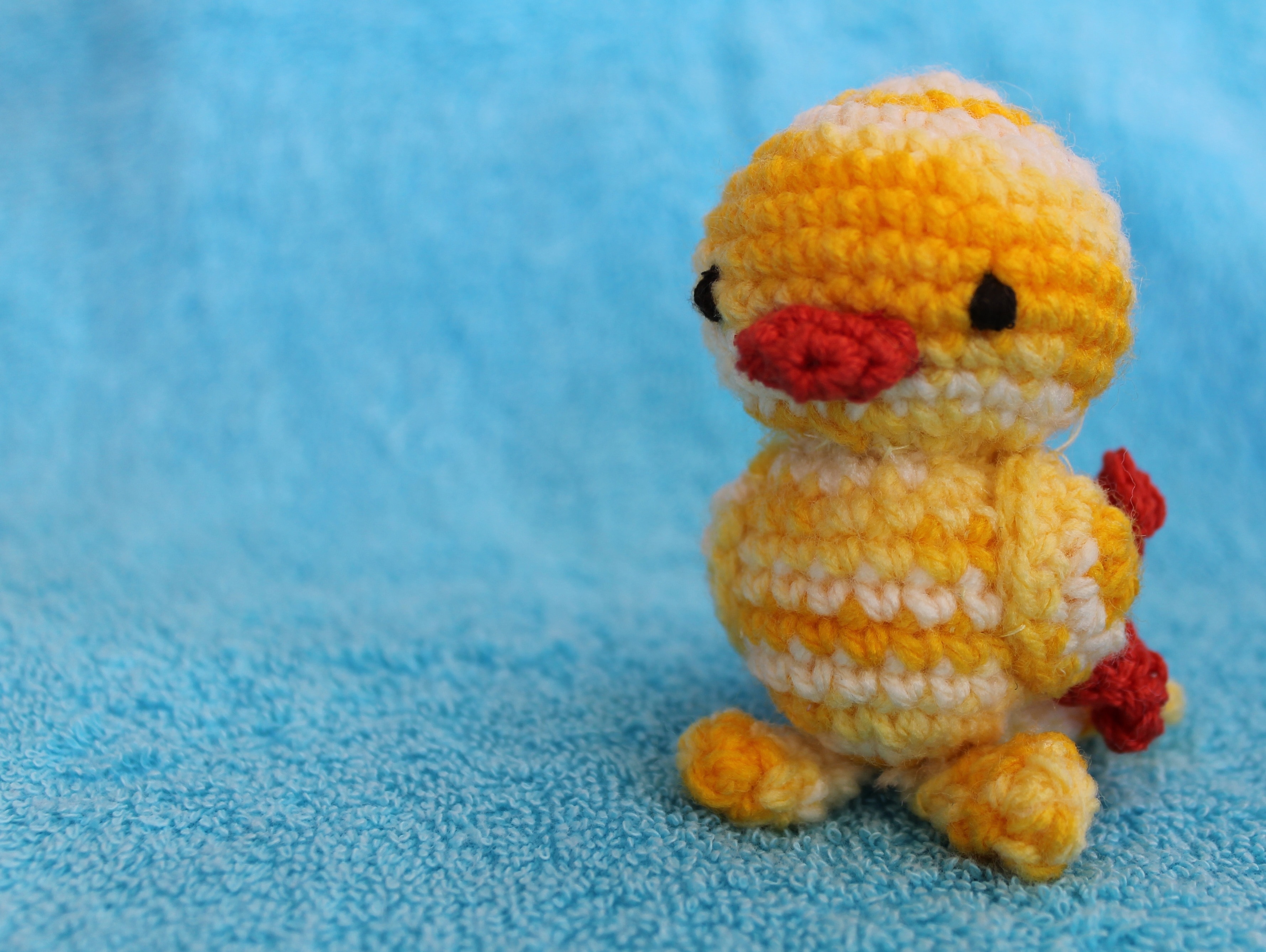 yellow white and red knit chick plush toy