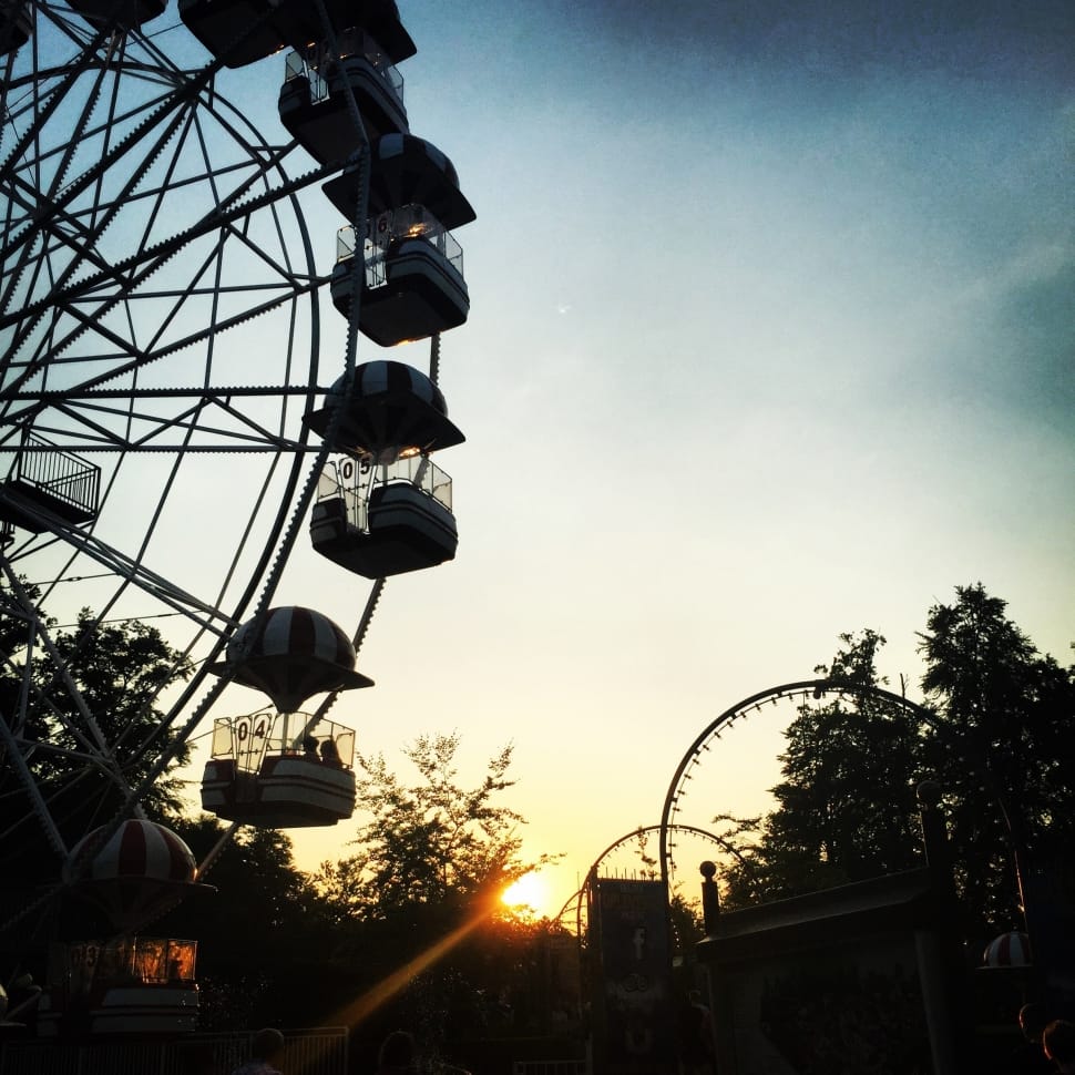 silhouette of ferris wheel during golden hour preview