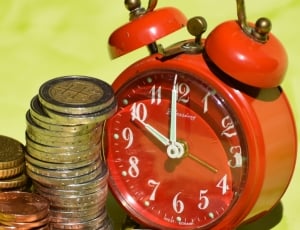 red bell alarm clock and assorted commemorative coin collection thumbnail