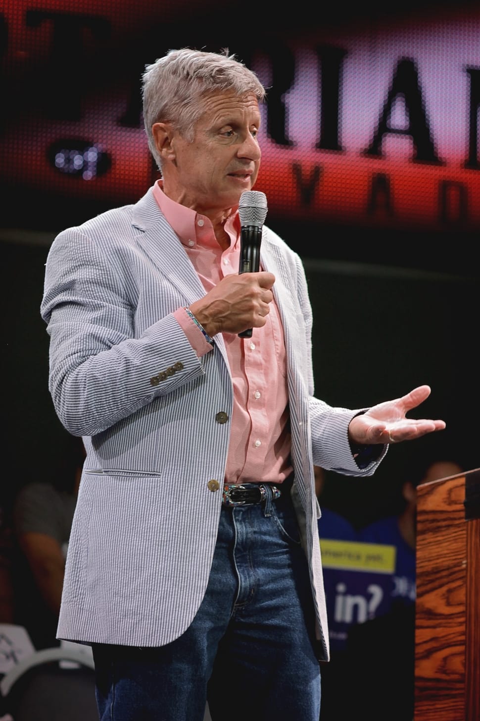 man wearing gray blazer,pink dress shirt and blue denim pants preview