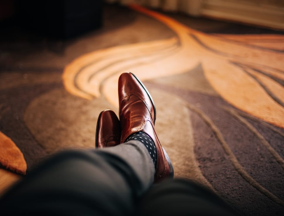 male wearing brown dress shoes left foot over right preview