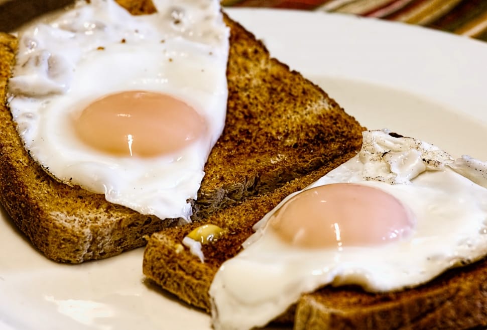 bread with egg on white round plates preview