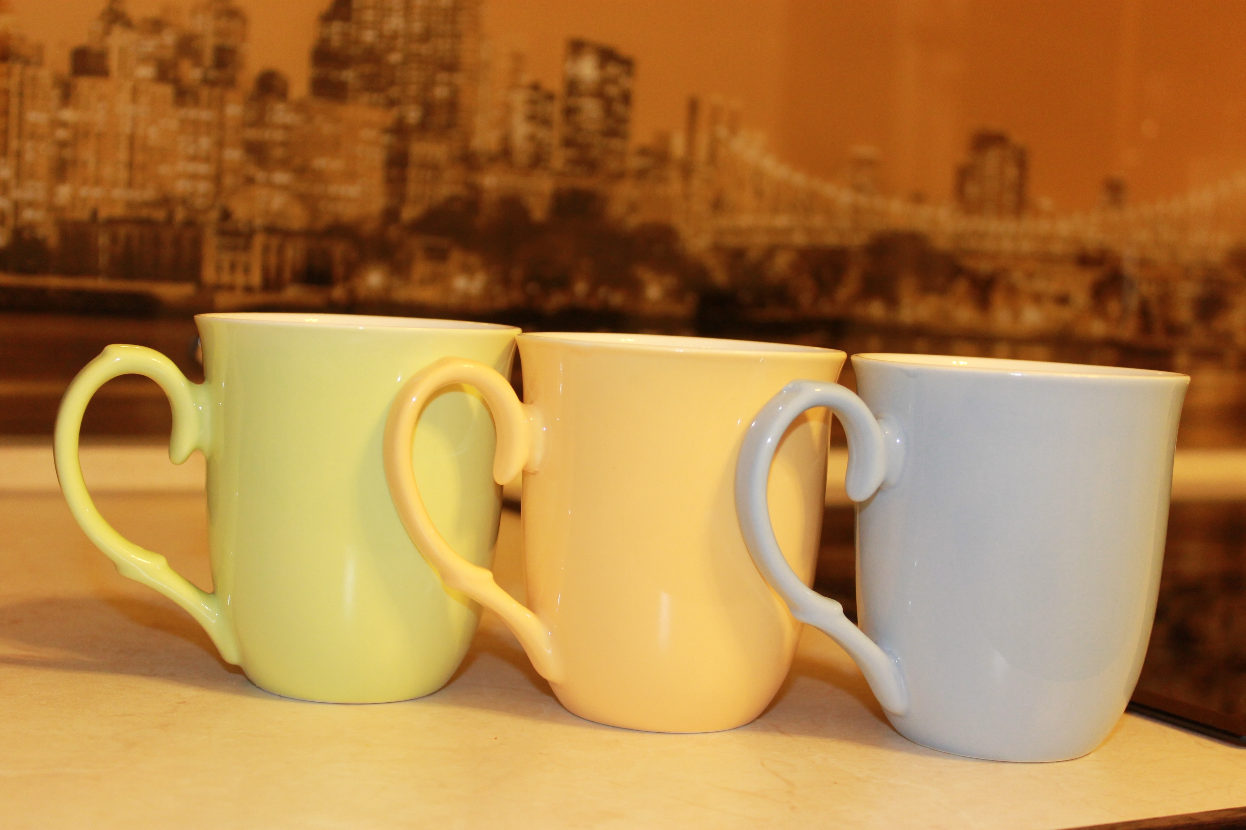 green yellow and gray ceramic mugs