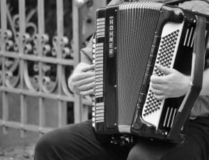 gray scale photography on human playing music instrument thumbnail