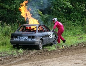 man near a burning car on rose side thumbnail