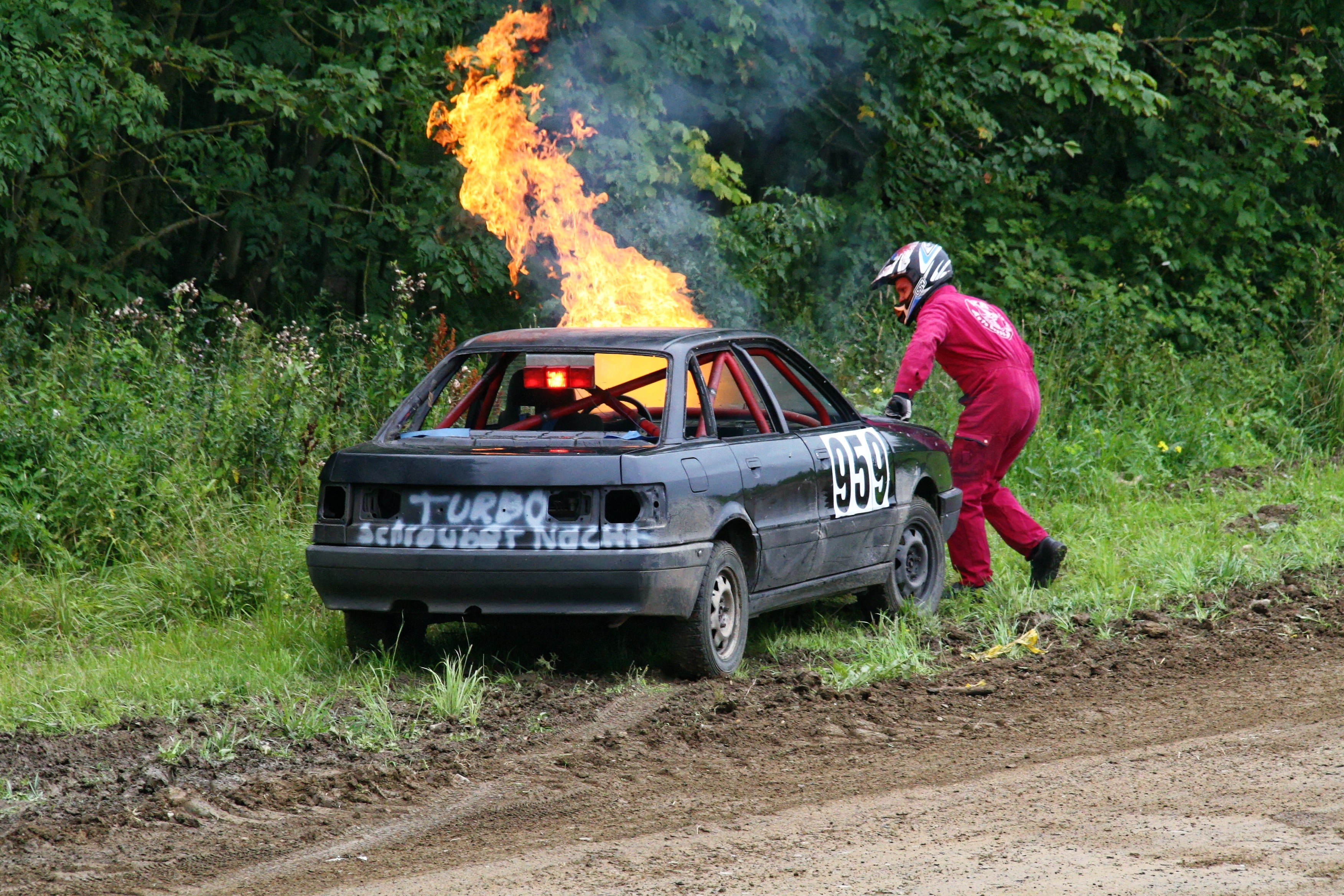 man near a burning car on rose side
