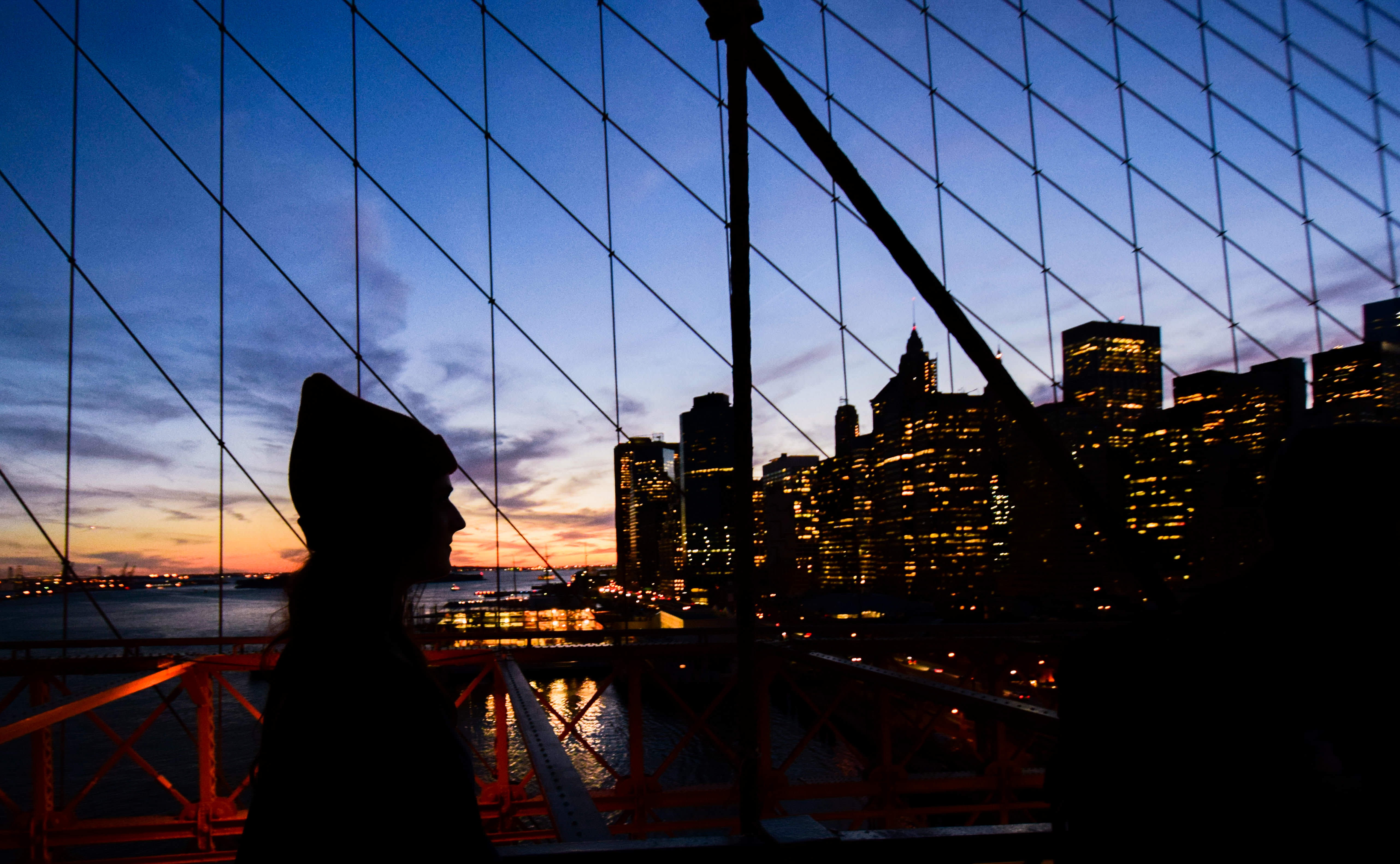 silhouette of woman standing facing city escape during night