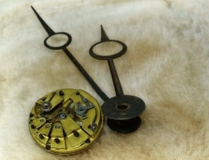 brown round metal and black clock pointer thumbnail