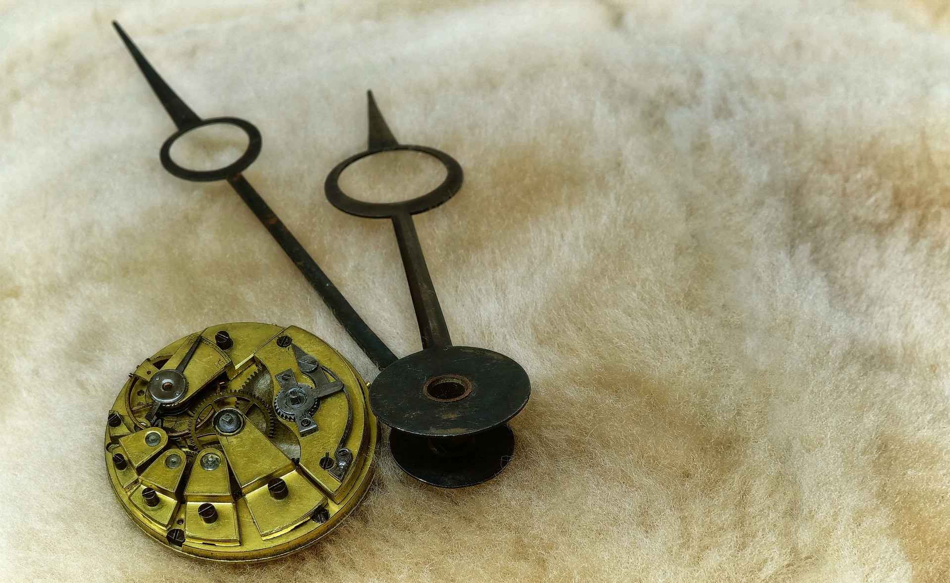 brown round metal and black clock pointer