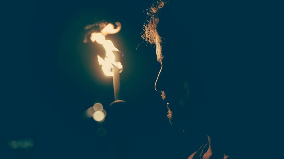man holding torch photo preview