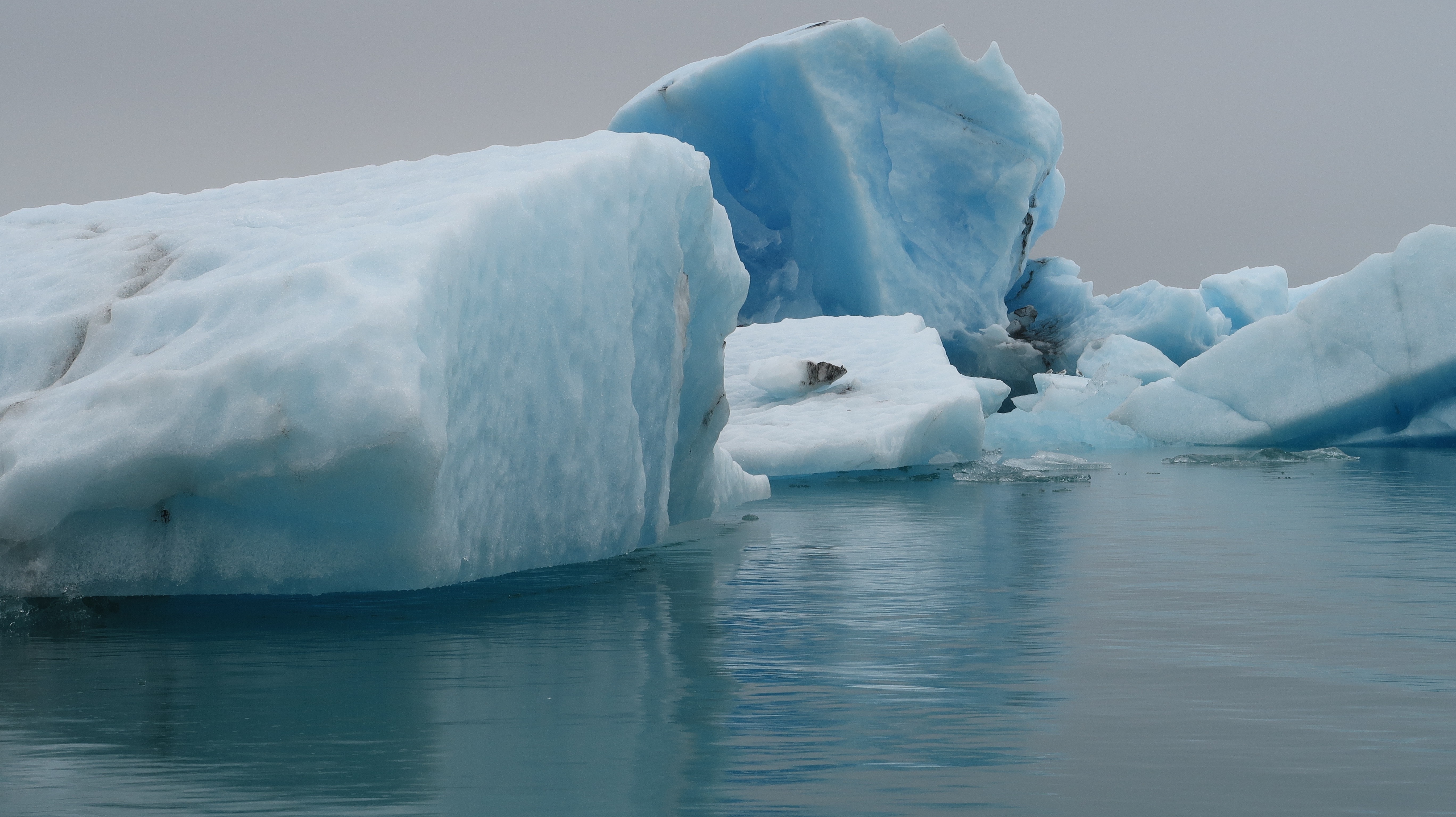ice berg in the middle of body of water