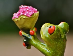 green ceramic frog holding bouquet of flower thumbnail