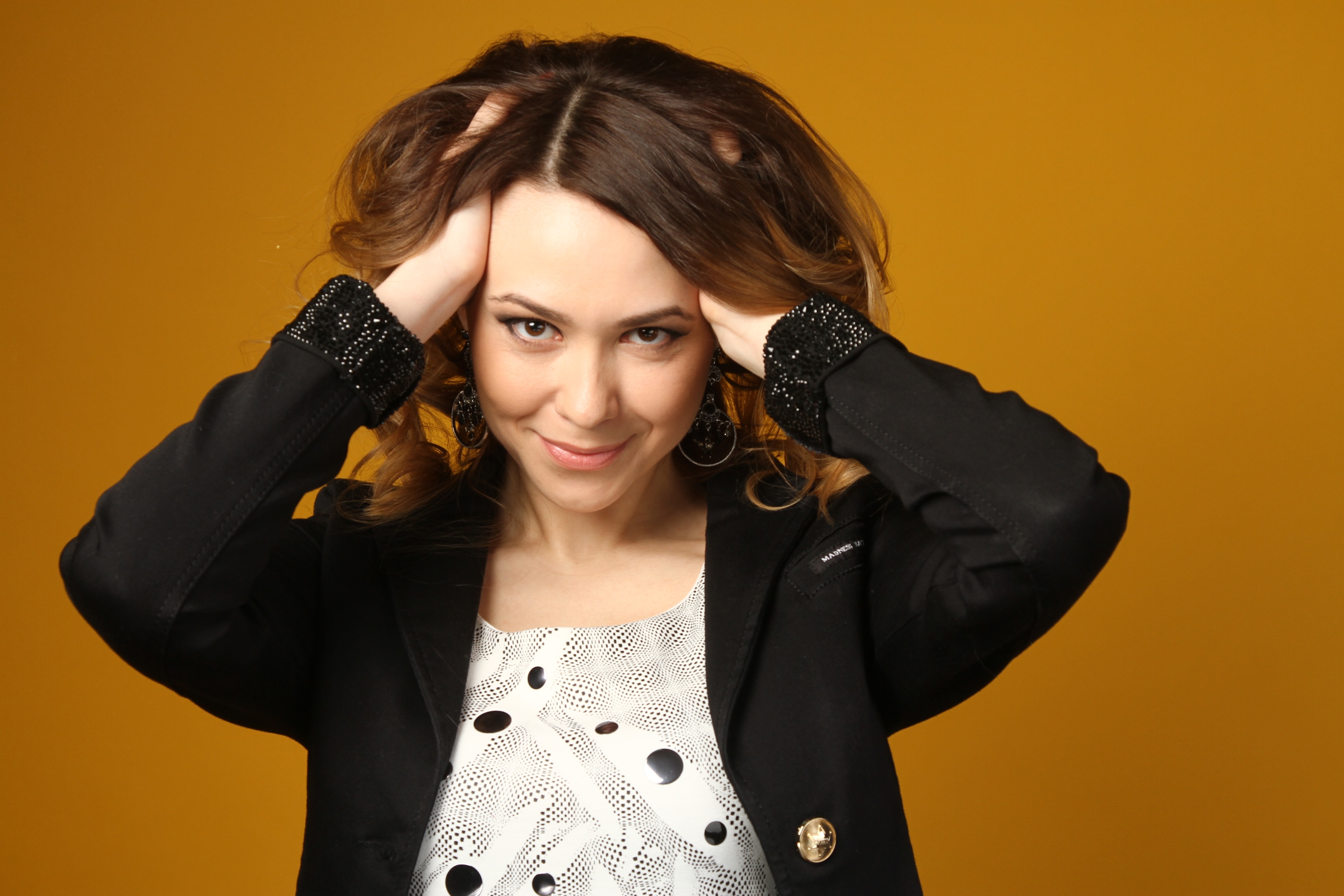 woman in black suit jacket holding brown hair taking photography