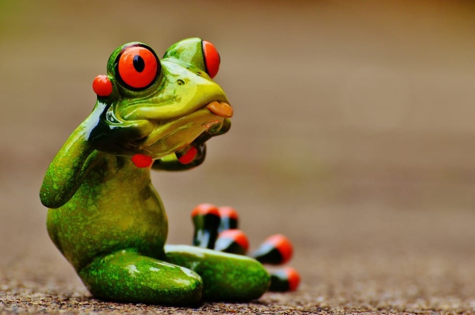 green red and black ceramic frog figurine preview