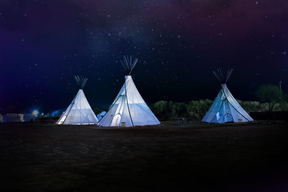 three white indian tents during nighttime preview