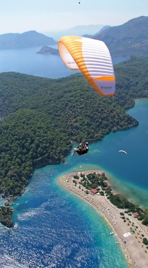 person paragliding during daytime thumbnail