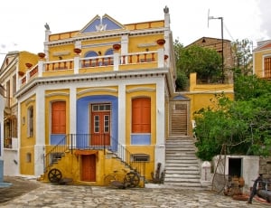 yellow white and blue painted house thumbnail