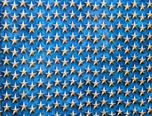 grey metal stars on blue wooden wall thumbnail