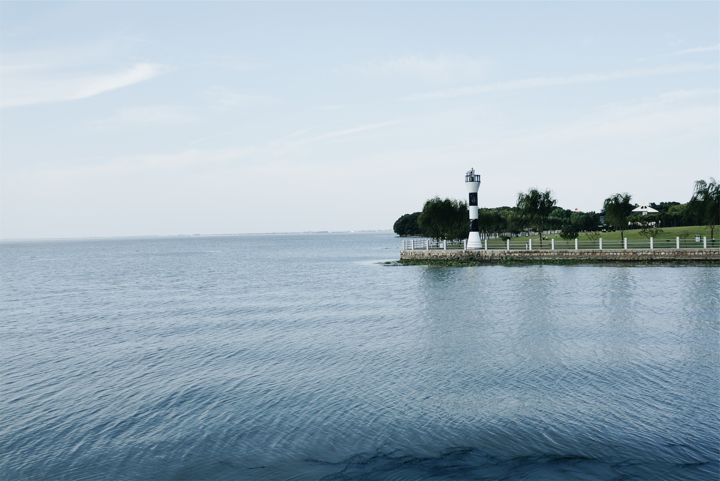 white and black tower near body of water