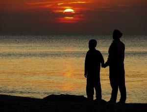 father and son watching the sun set thumbnail