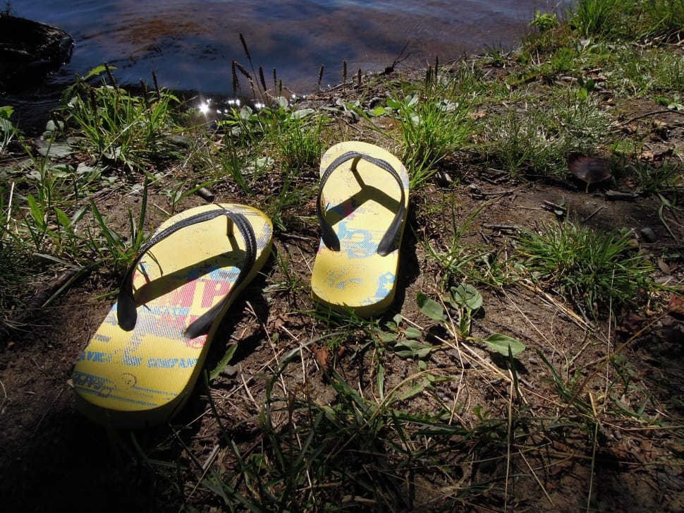 pair of yellow and black flipflops preview
