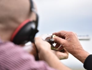 person holding brown single action rifle thumbnail