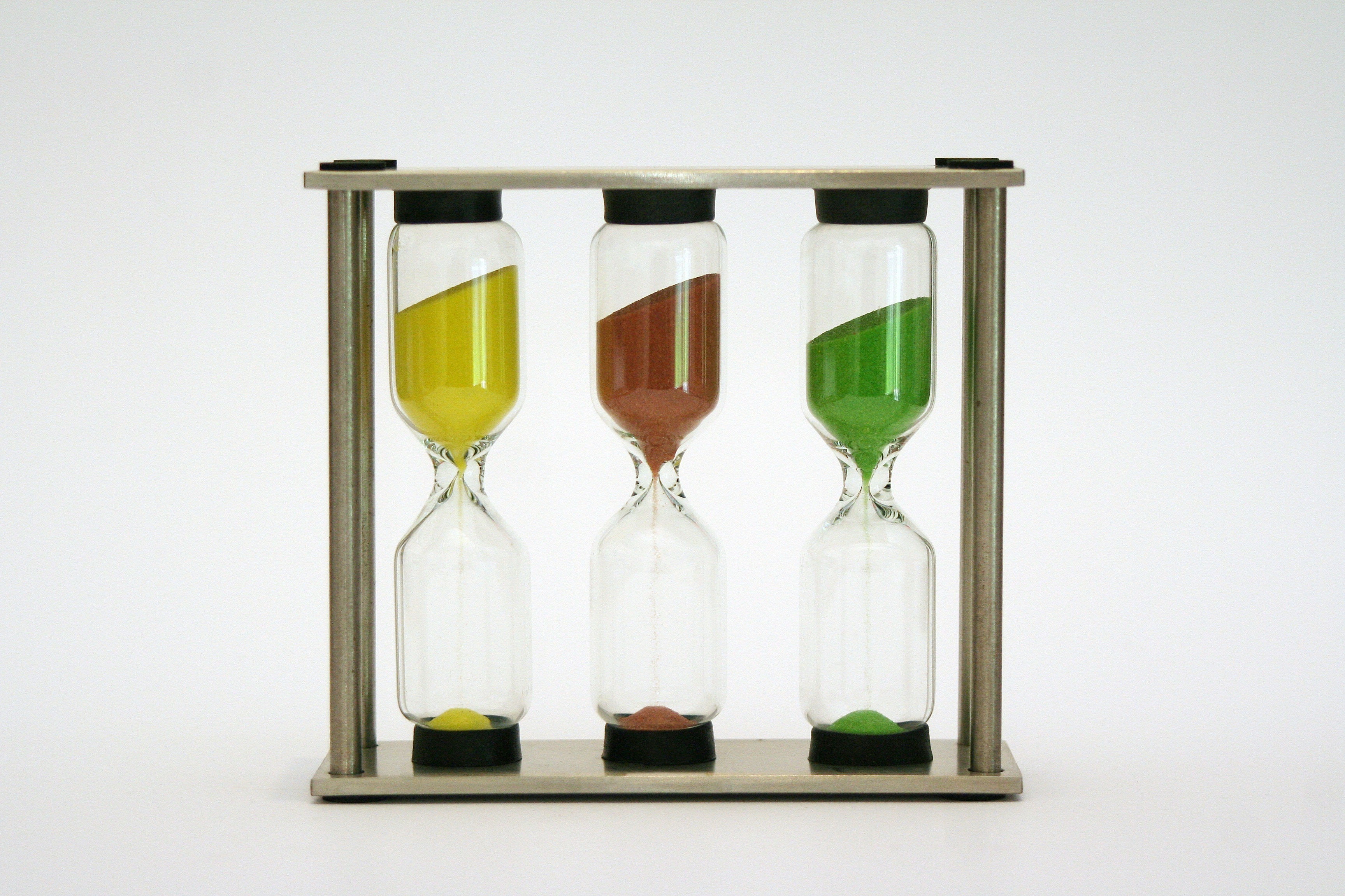 three yellow,brown and green hour glass