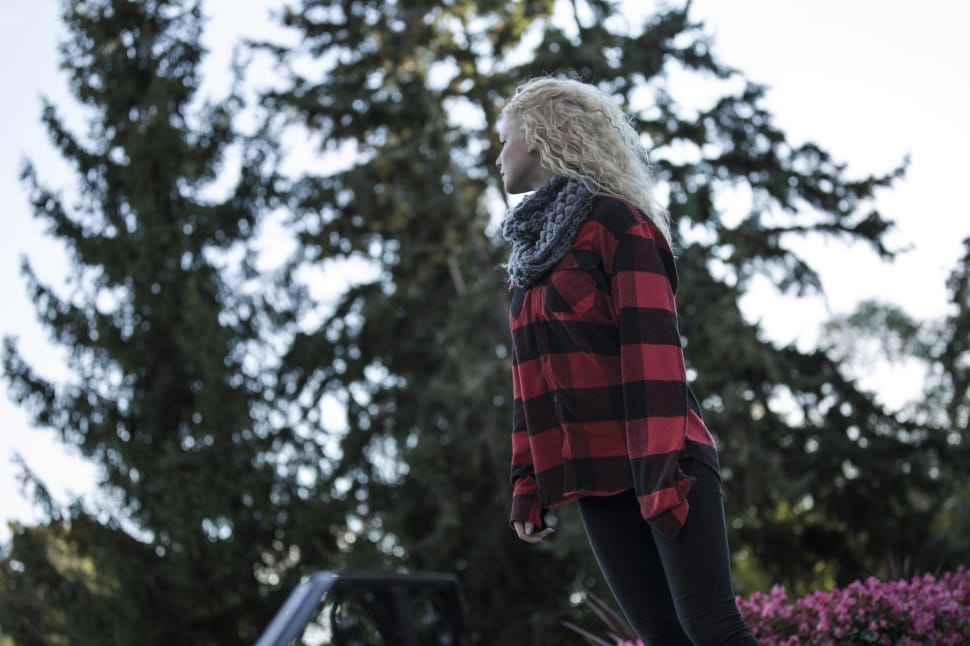 woman in red and black plaid coat standing during daytime preview