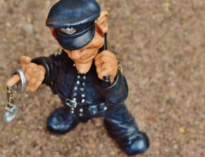police holding hand cuffs figurine thumbnail