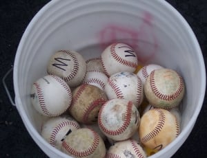 baseballs and white plastic pail thumbnail