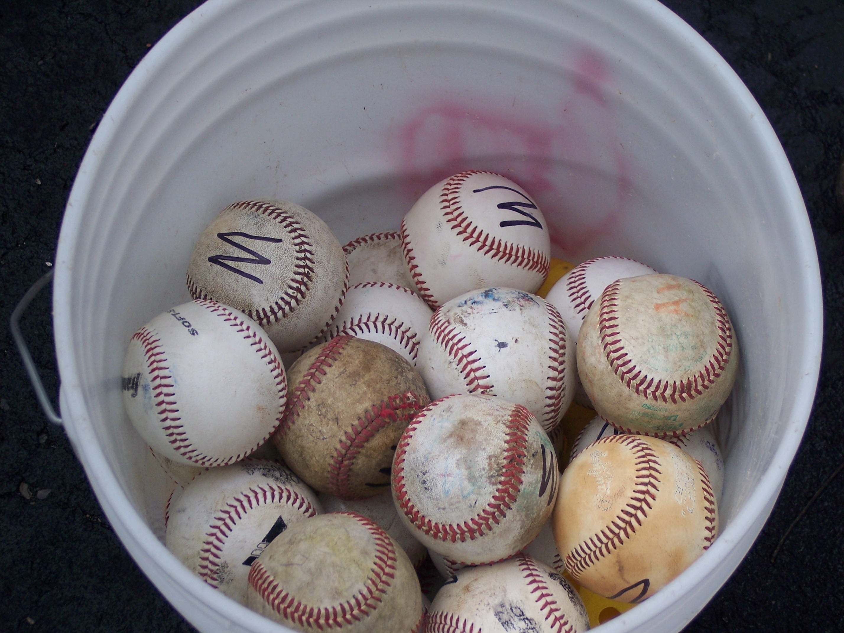 baseballs and white plastic pail