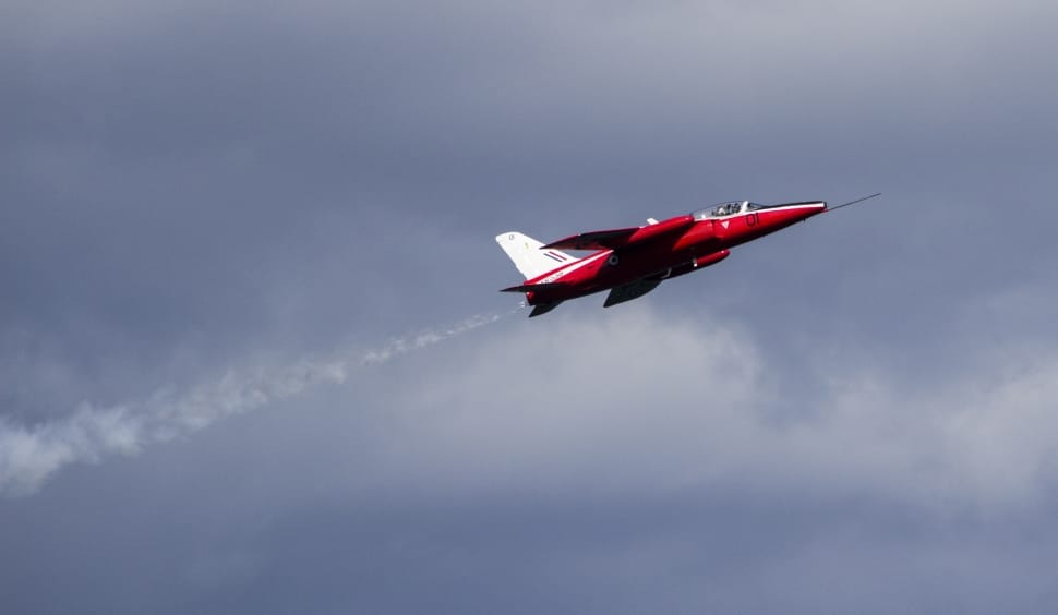 red and white jet in the skies preview