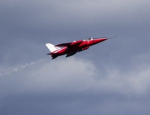 red and white jet in the skies thumbnail