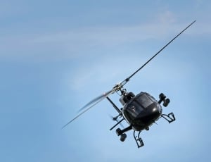 black helicopter under blue sky thumbnail