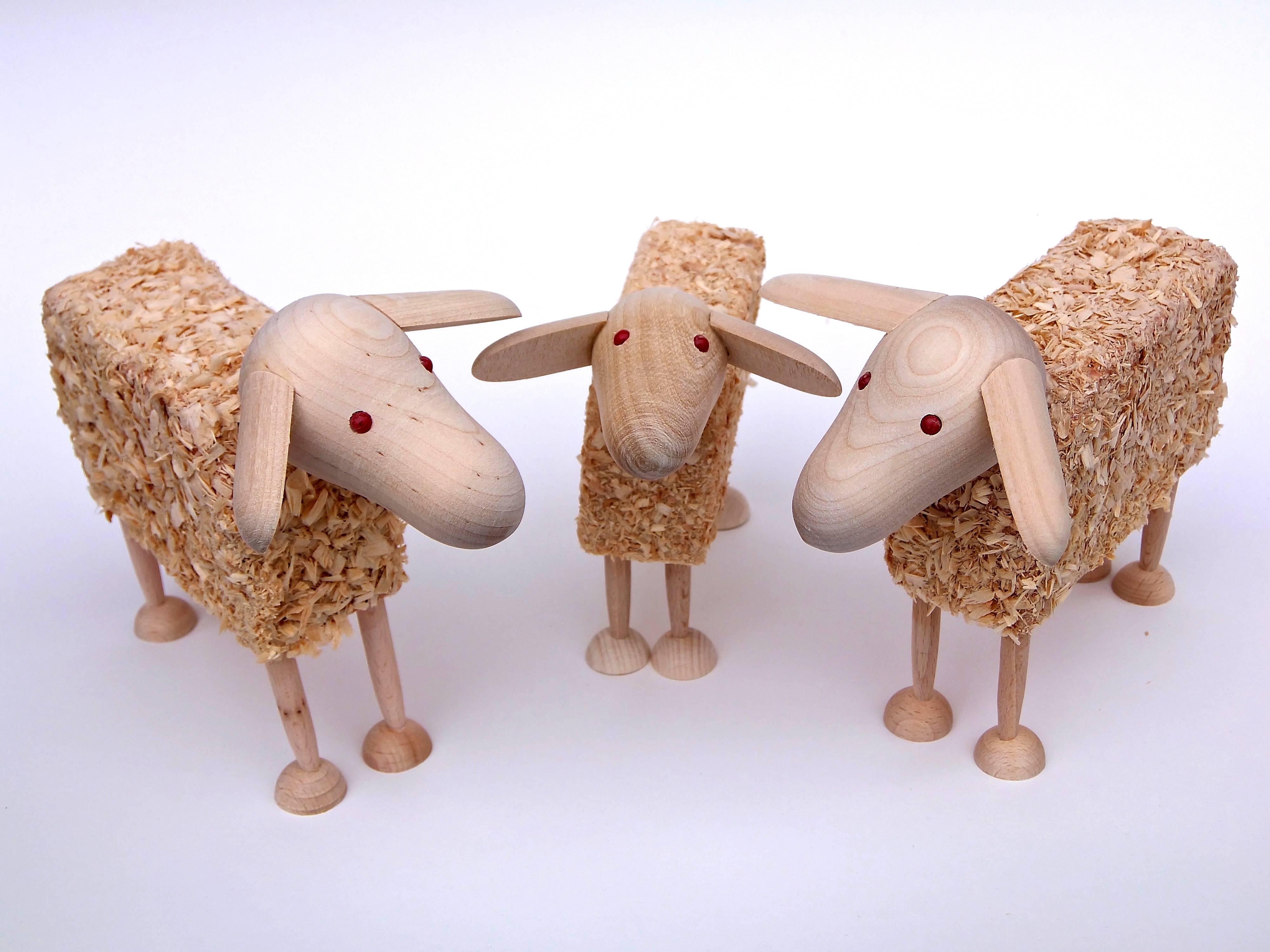 3 brown wooden sheep figurines