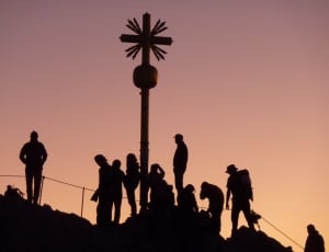 silhouette of people and cross statue thumbnail
