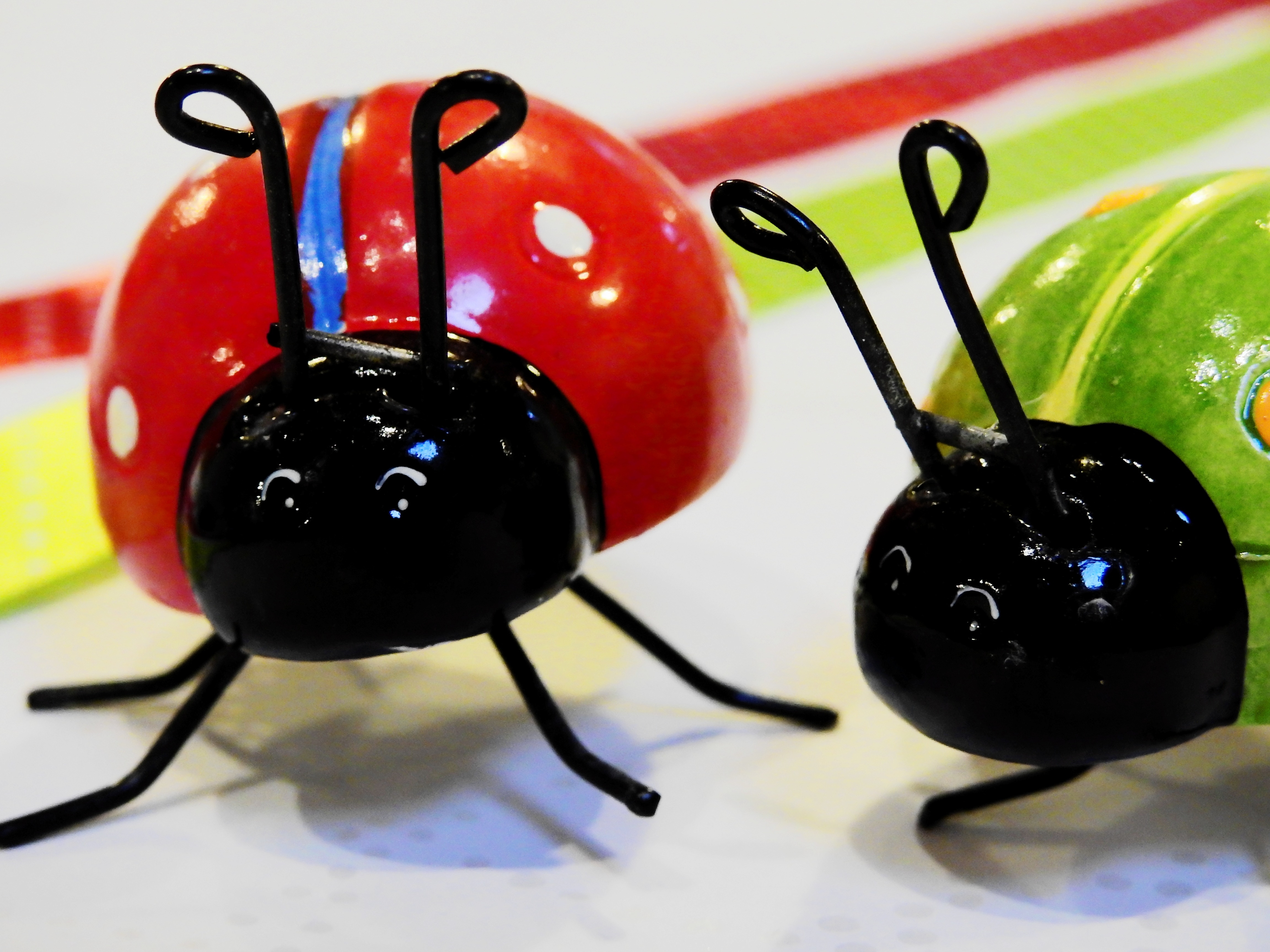 2 red and green lady bug toys