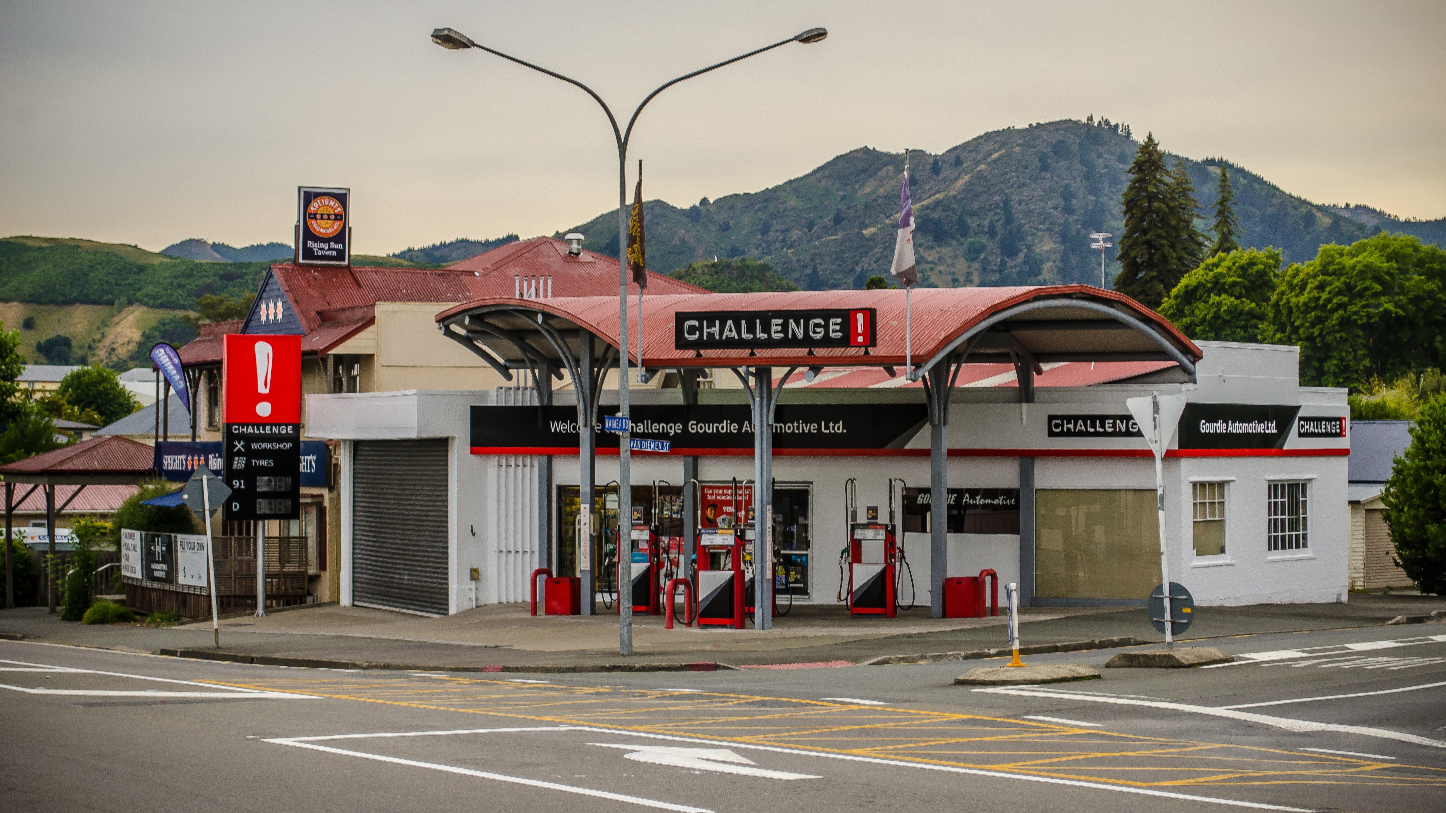 red and gray challenge gasoline station