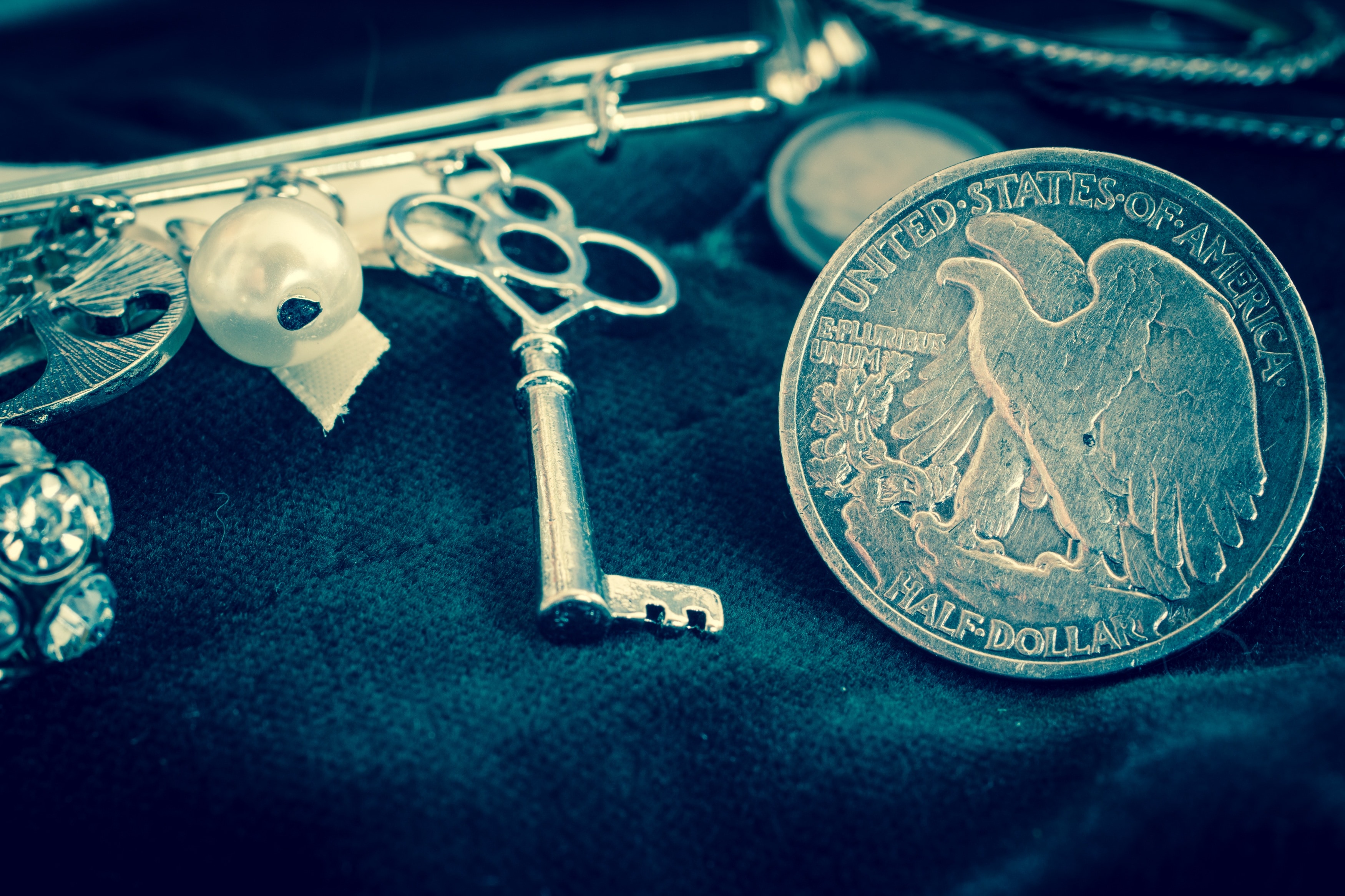 gold round coin and skeleton key